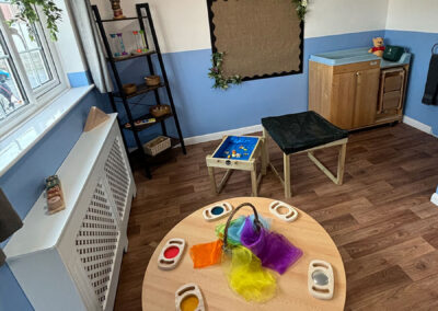 Tables set up for various activities in baby room at Clarence House Boston